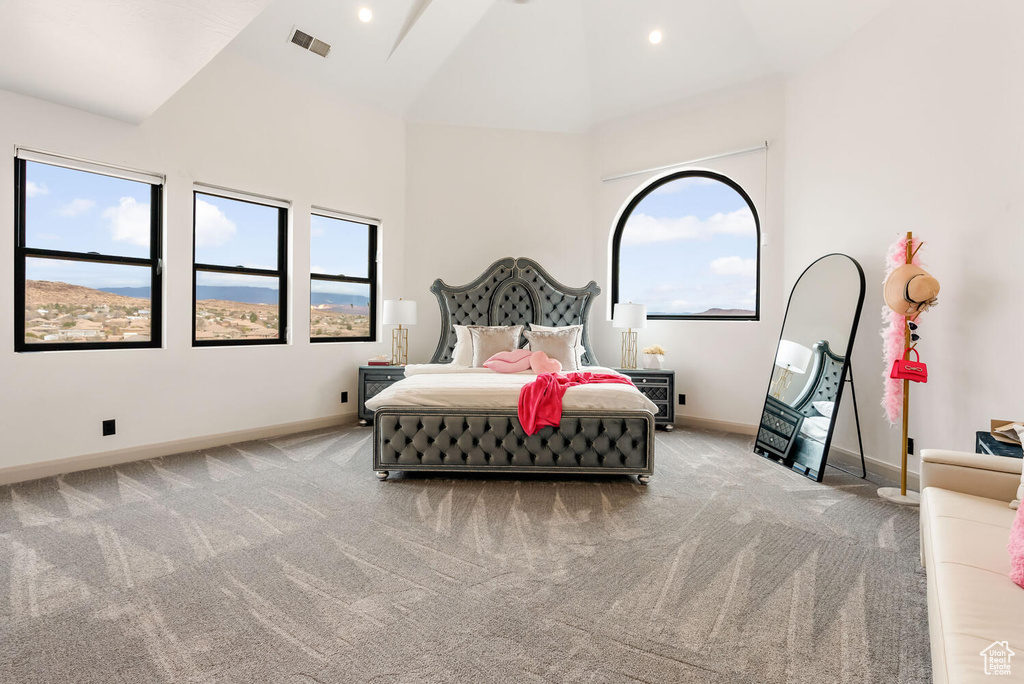Bedroom featuring baseboards, multiple windows, high vaulted ceiling, carpet flooring, and recessed lighting