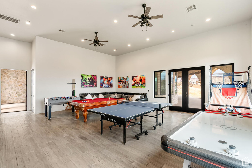 Game room with a high ceiling, a ceiling fan, light wood finished floors, and recessed lighting