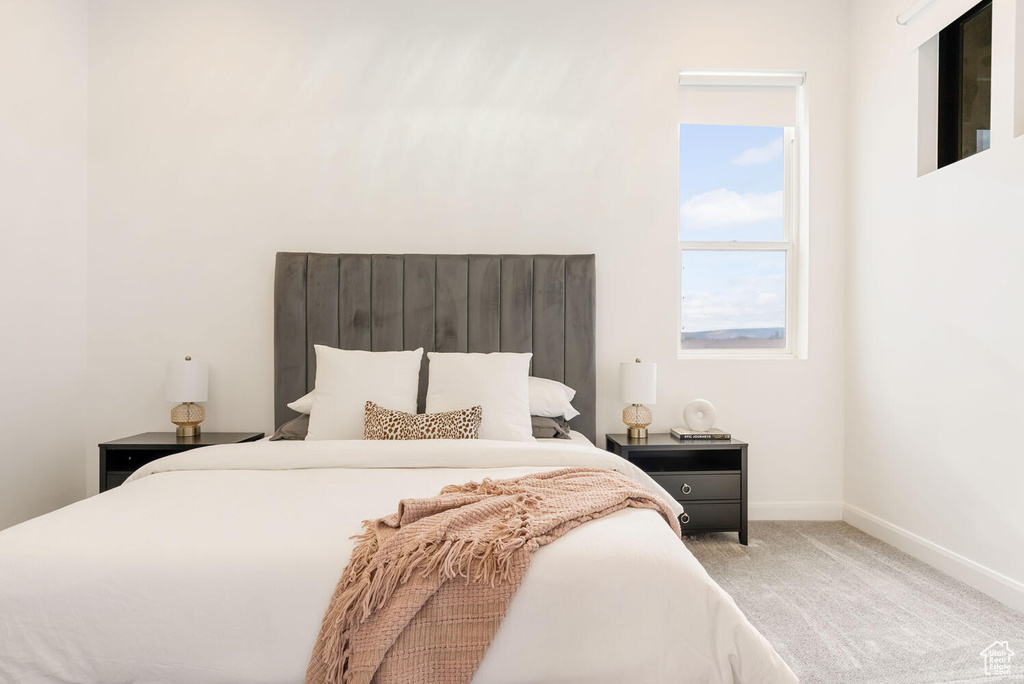 Carpeted bedroom featuring baseboards