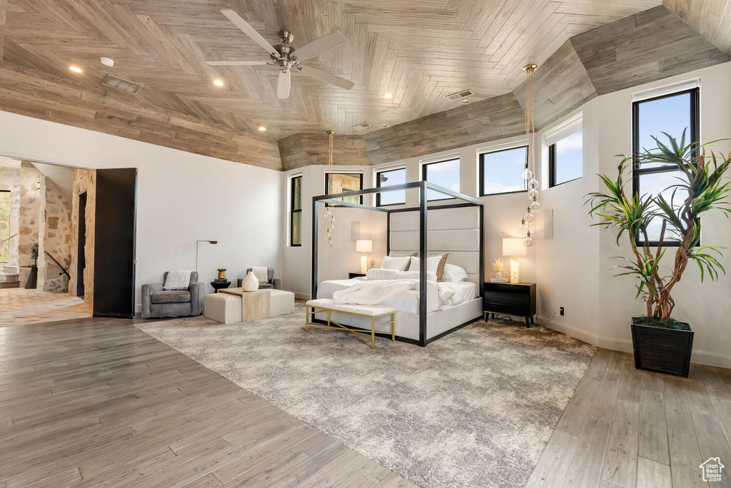 Bedroom with wood finished floors, recessed lighting, and baseboards