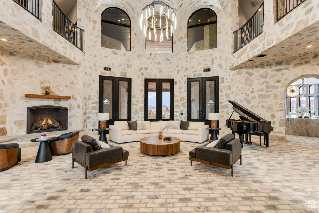 View of patio / terrace featuring french doors, a balcony, and an outdoor living space with a fireplace