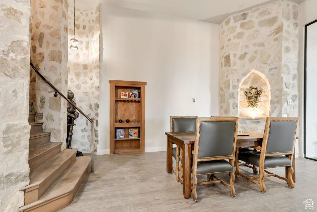 Dining area featuring wood finished floors, baseboards, and stairs