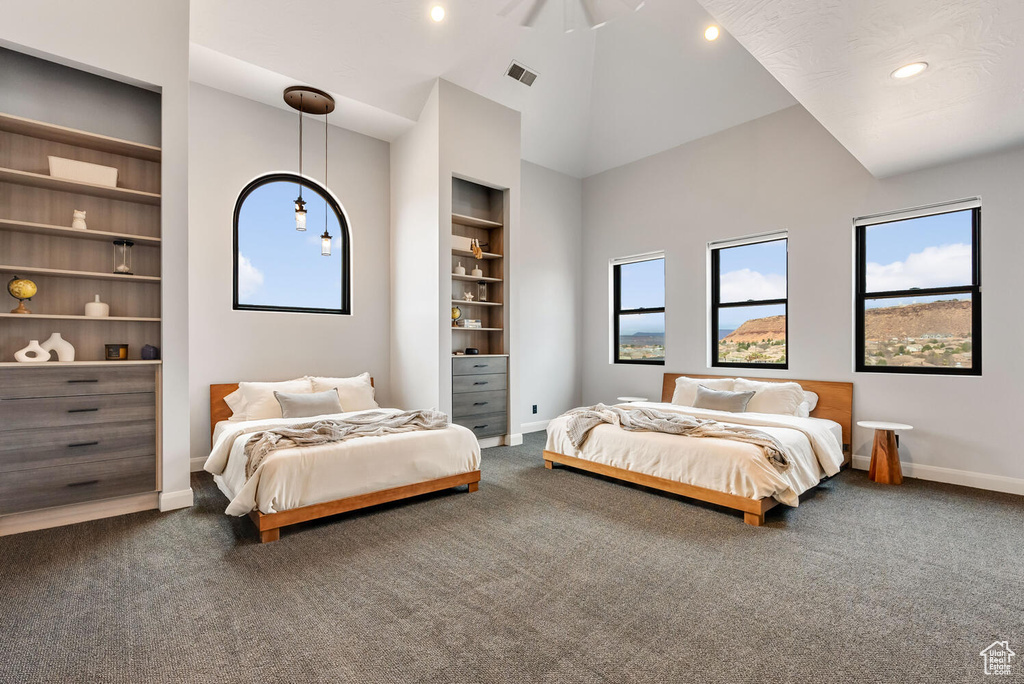 Bedroom with baseboards, dark colored carpet, recessed lighting, and high vaulted ceiling