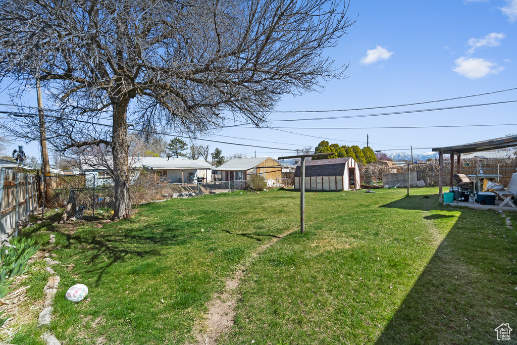 View of yard with a storage unit and an outbuilding