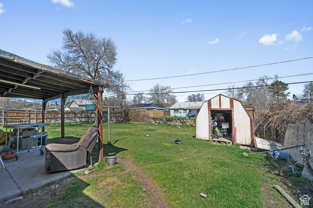 View of yard with a storage shed and an outdoor structure
