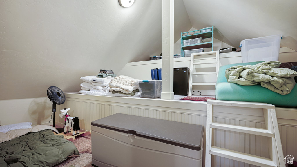 Carpeted bedroom featuring lofted ceiling