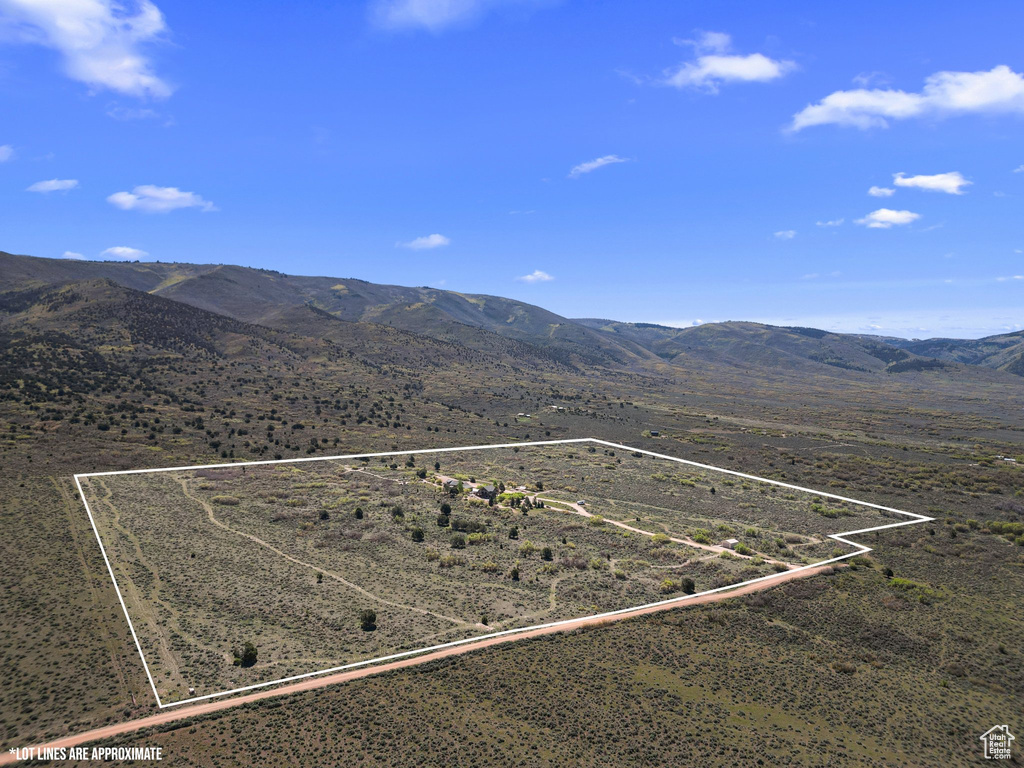 Aerial view of sparsely populated area featuring property boundaries highlighted and mountains