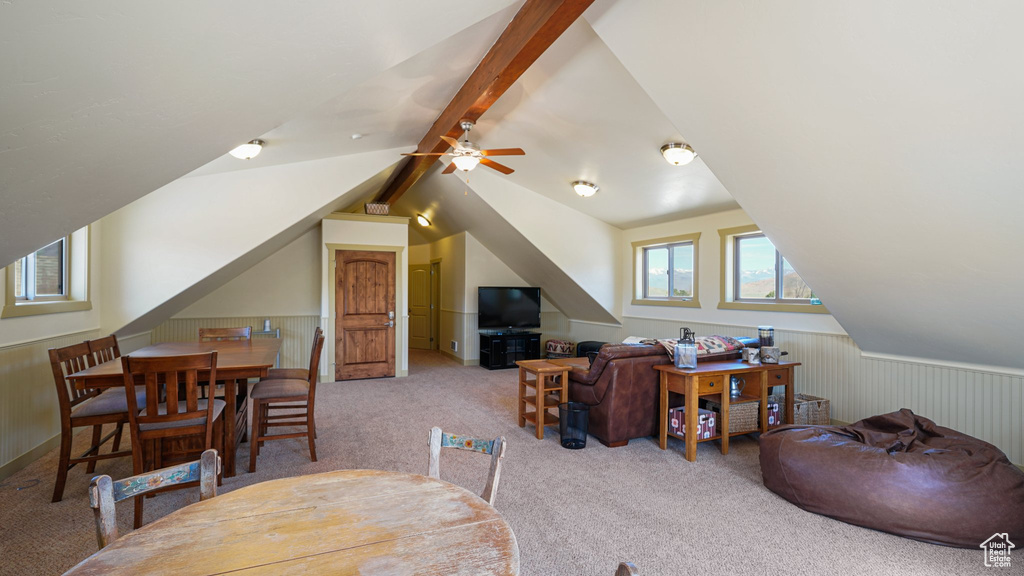 Living area with carpet floors, ceiling fan, and wainscoting