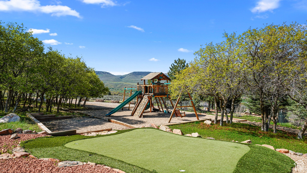 Community jungle gym with a putting area and a mountain view