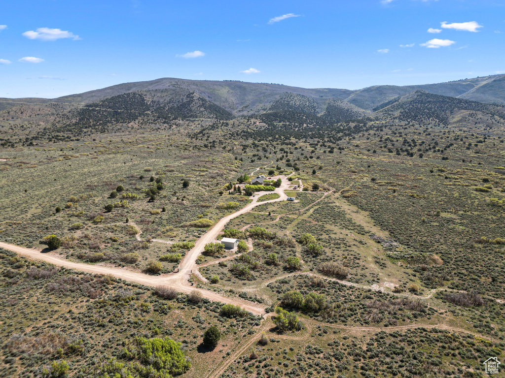 Aerial view of sparsely populated area with a mountain backdrop and a desert landscape