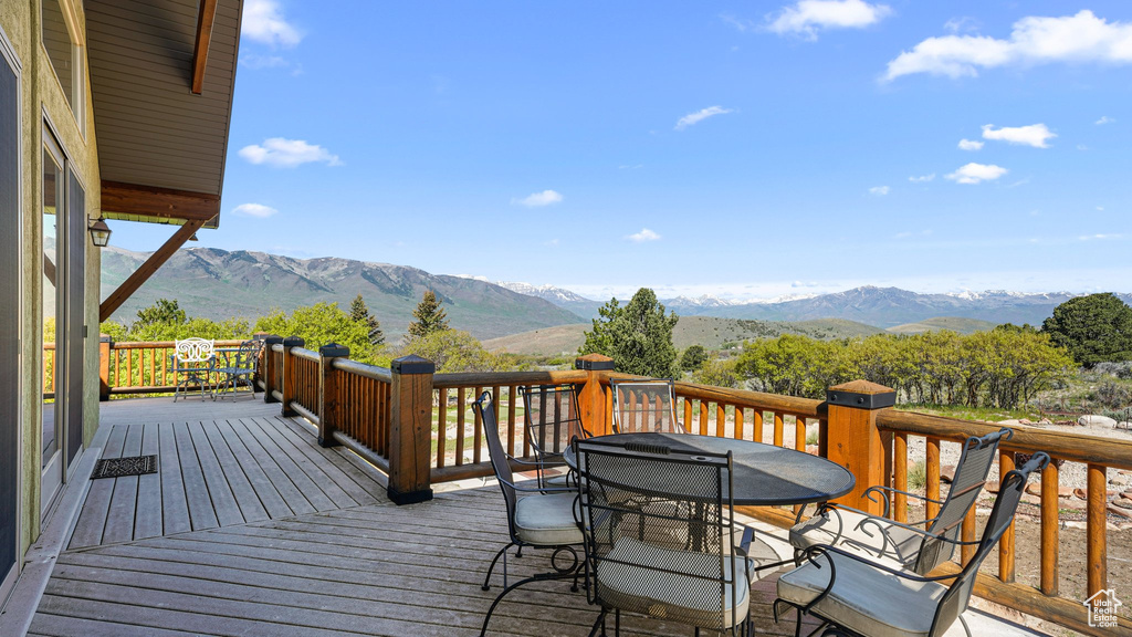 Deck featuring outdoor dining area and a mountain view