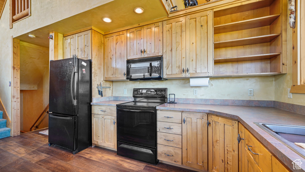 Kitchen with black appliances, dark wood-type flooring, open shelves, a sink, and recessed lighting