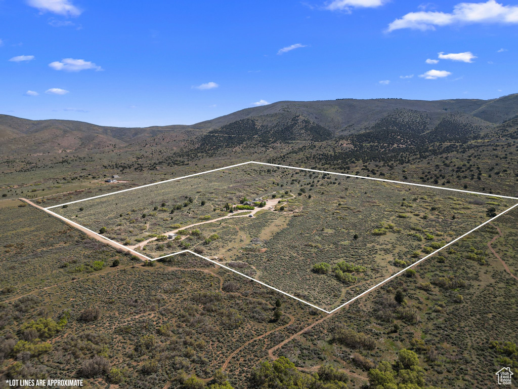 Aerial view of sparsely populated area featuring property boundaries highlighted and mountains