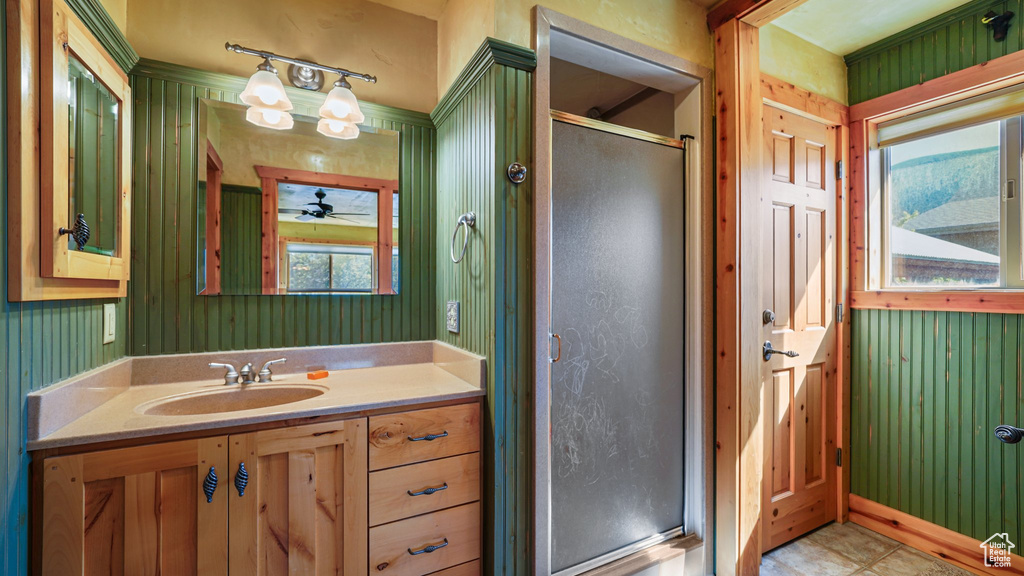 Full bathroom with a shower stall, vanity, and a ceiling fan