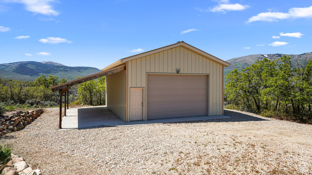 Garage featuring a mountain view and a detached garage