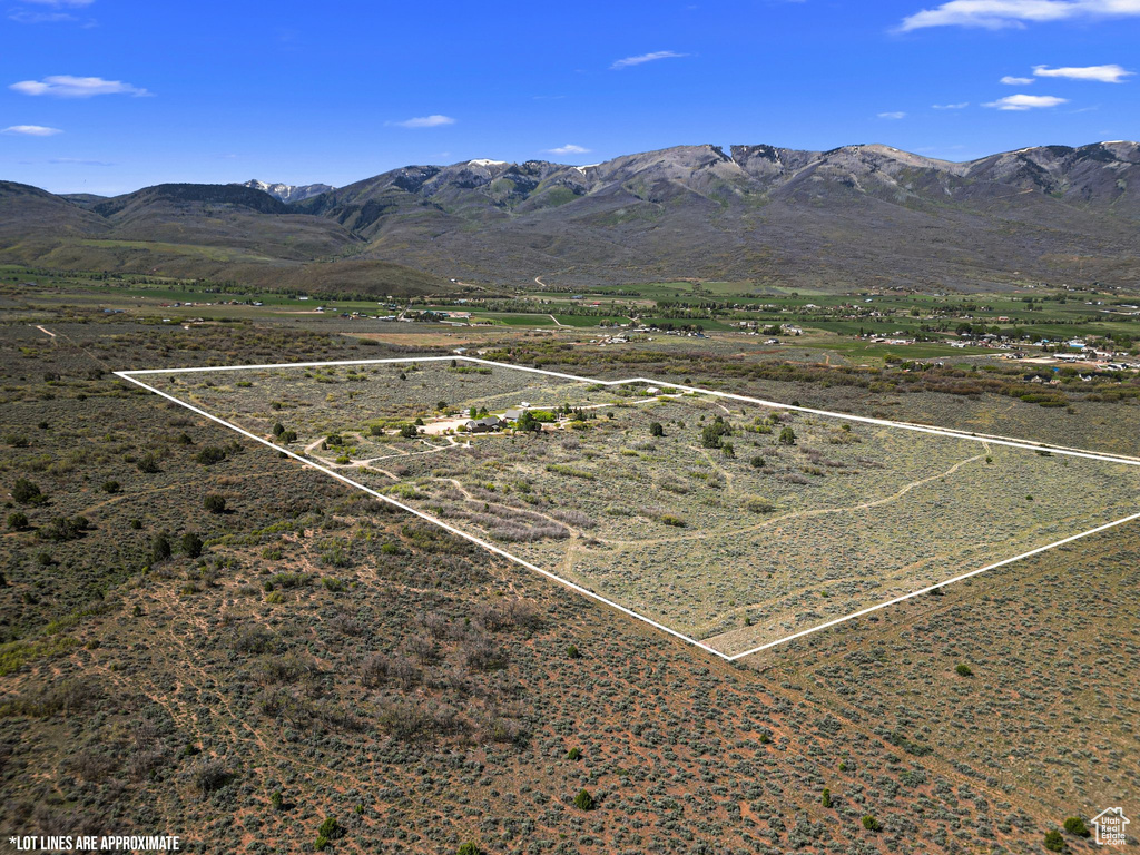 Overview of rural landscape featuring property parcel outlined and a mountain backdrop