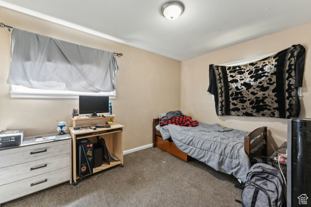 Bedroom with carpet flooring and baseboards