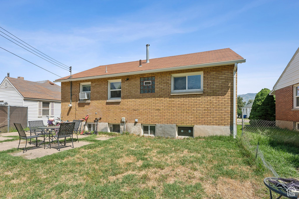 Back of property featuring a patio and brick siding