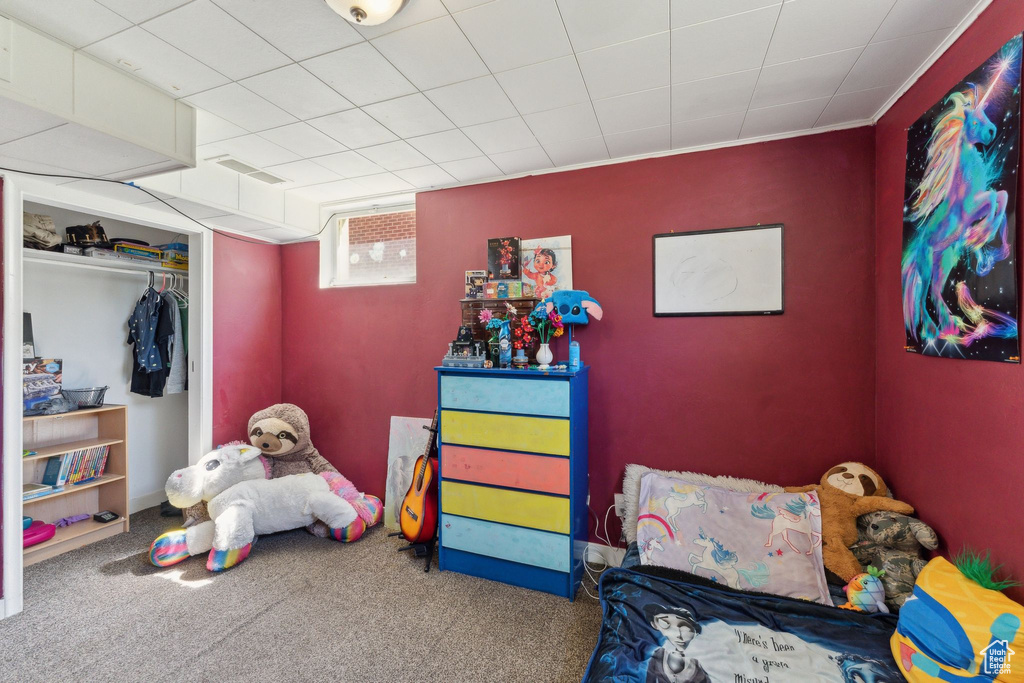 Bedroom featuring carpet flooring and a closet