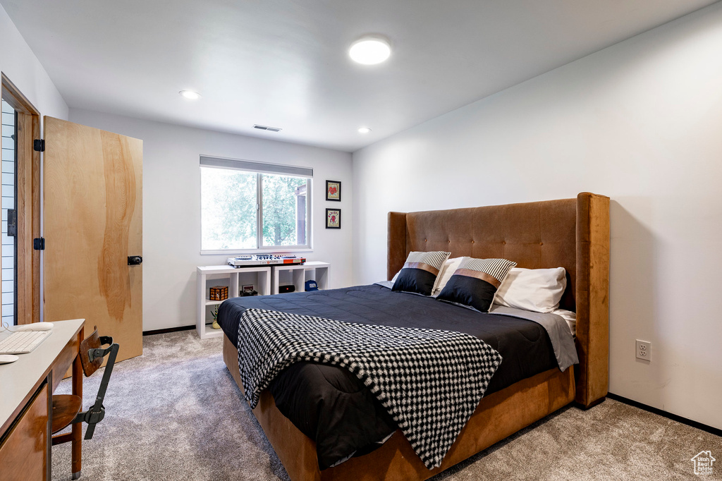 Bedroom featuring light colored carpet, recessed lighting, and baseboards