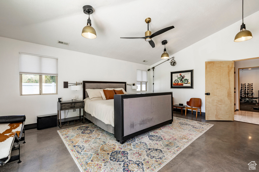 Bedroom featuring concrete floors and lofted ceiling