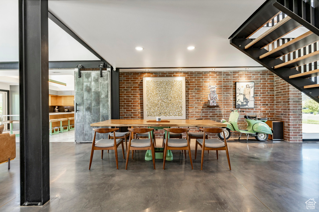 Dining room featuring brick wall and recessed lighting
