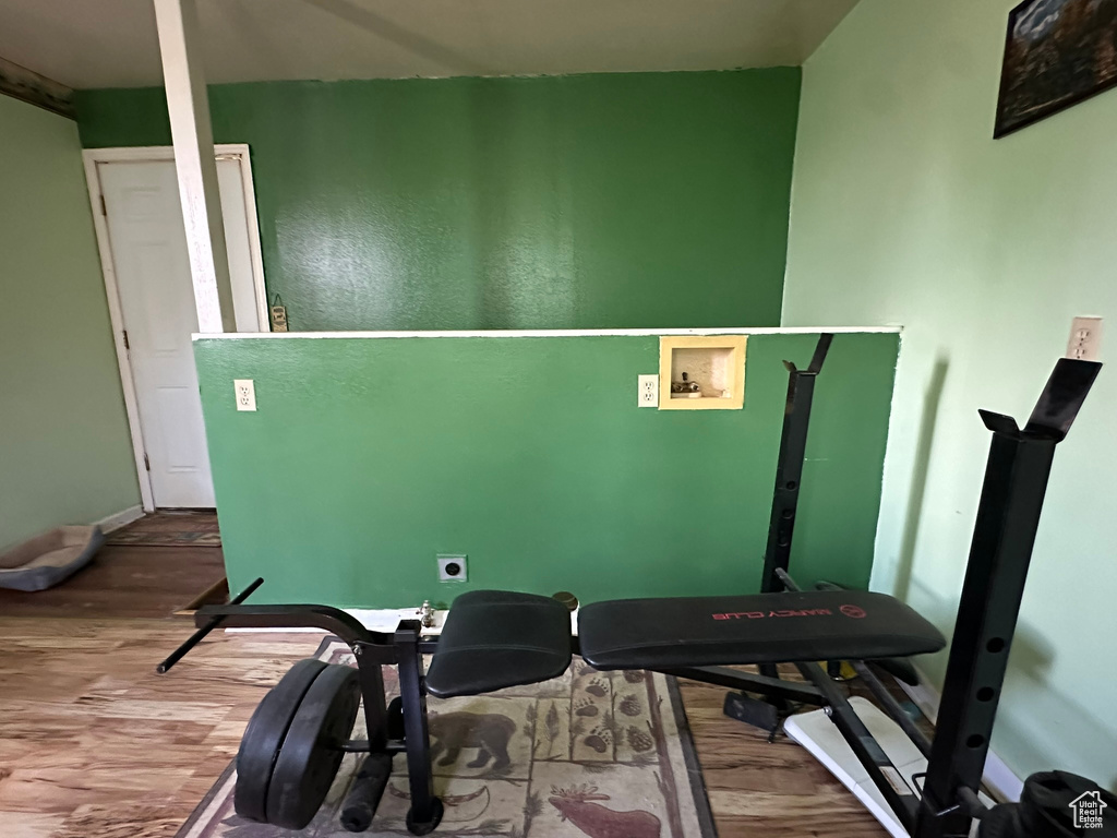 Exercise area featuring wood finished floors and baseboards