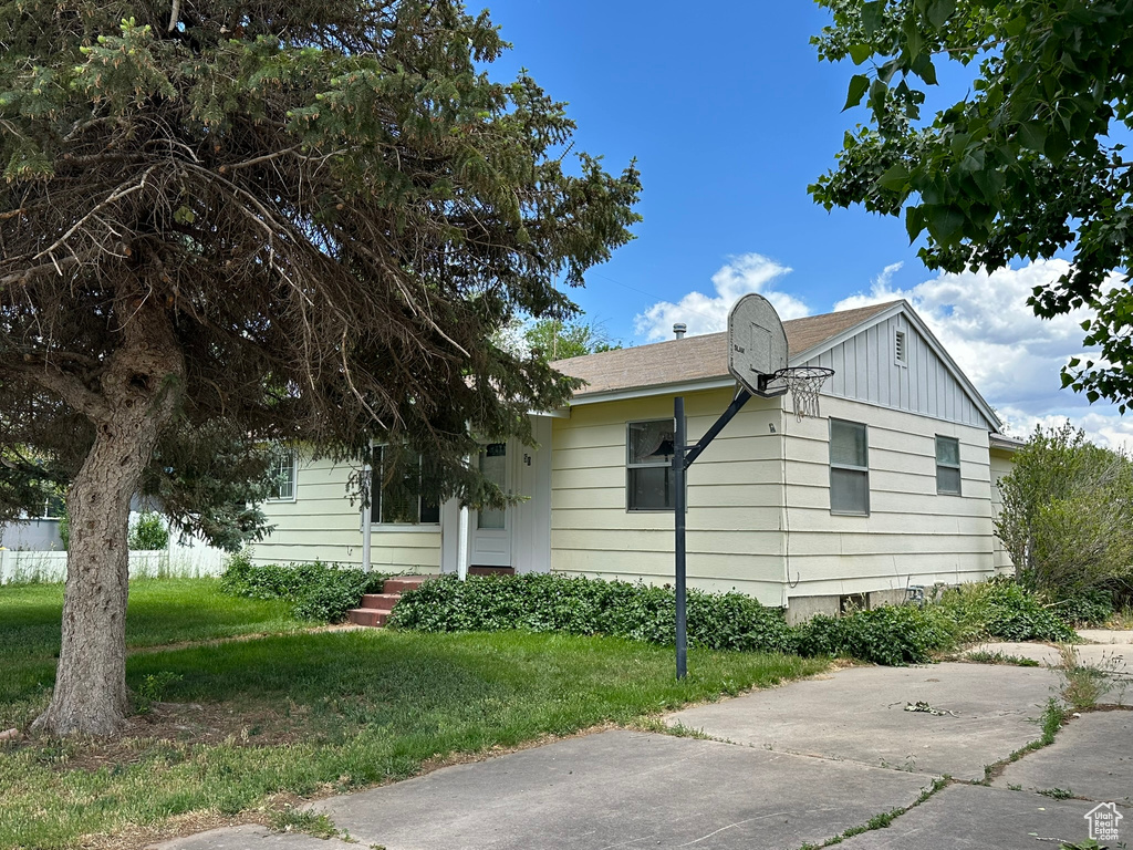 View of home's exterior featuring a yard and board and batten siding