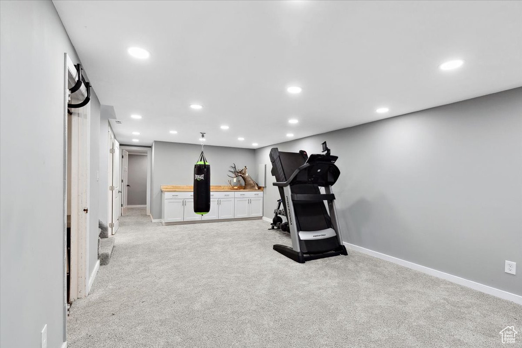 Exercise area featuring light carpet, recessed lighting, and baseboards