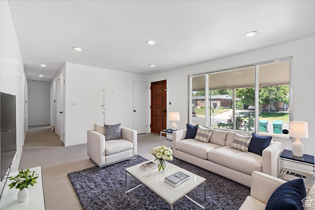 Living area with recessed lighting and baseboards