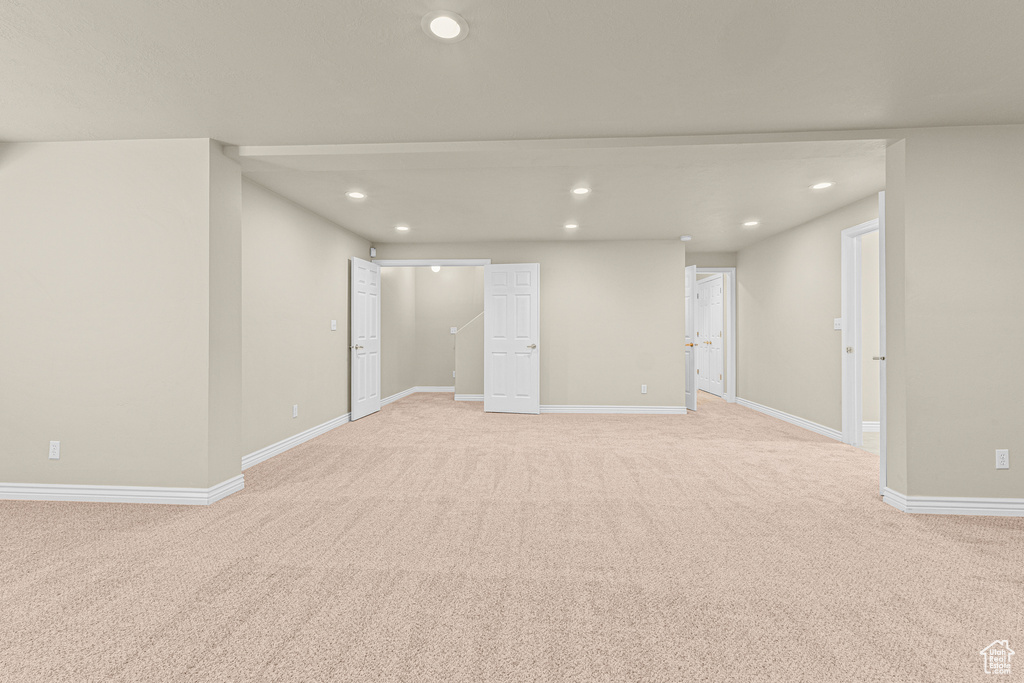 Empty room featuring recessed lighting, light colored carpet, and baseboards