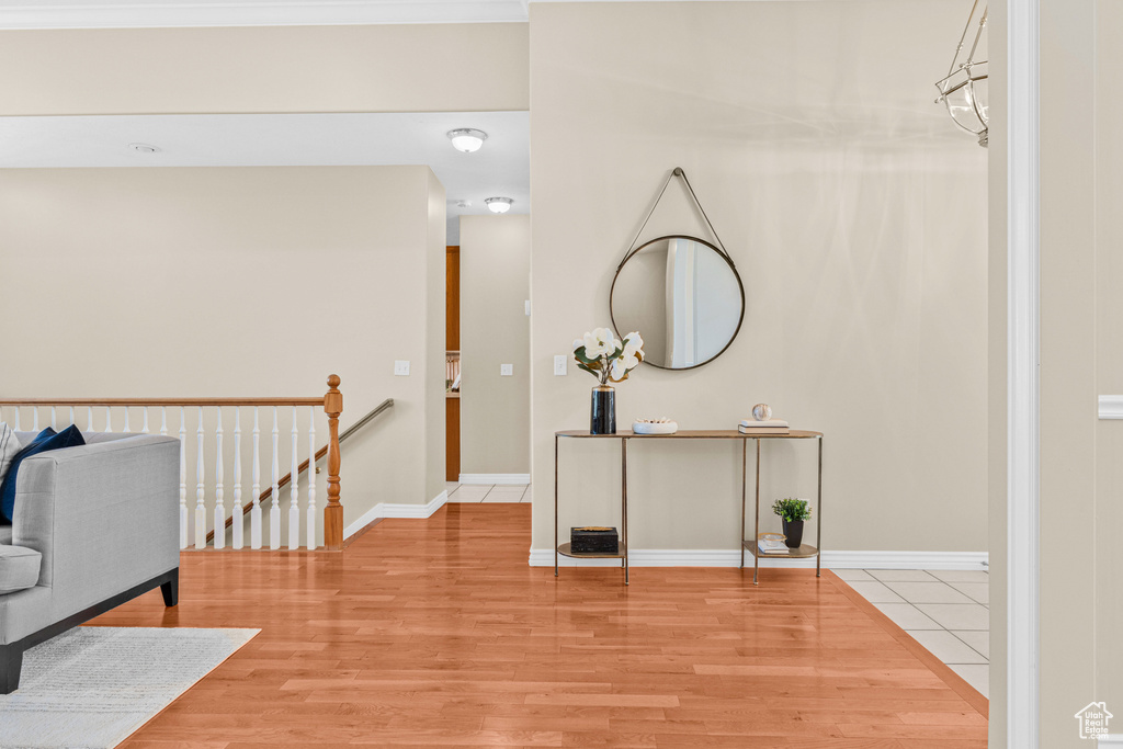 Corridor featuring light wood-style flooring and baseboards