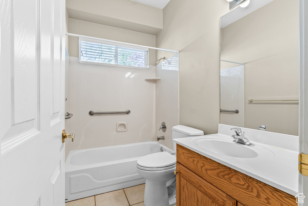 Bathroom with bathtub / shower combination, vanity, toilet, and tile patterned flooring