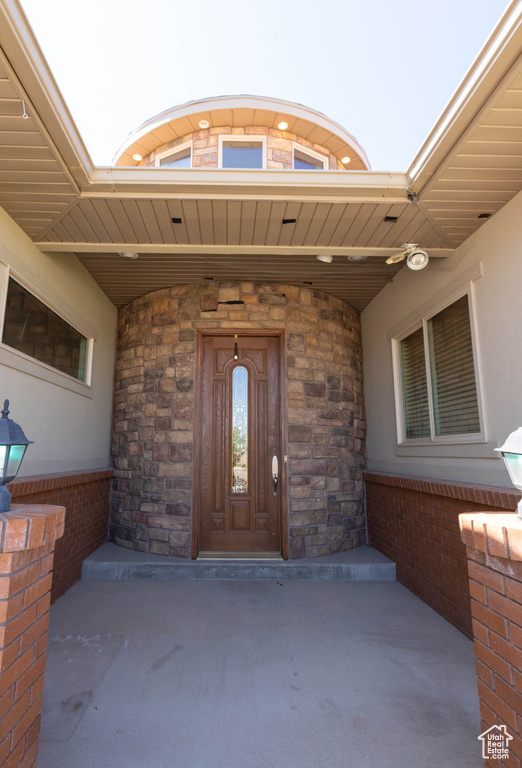 View of exterior entry with stone siding and stucco siding