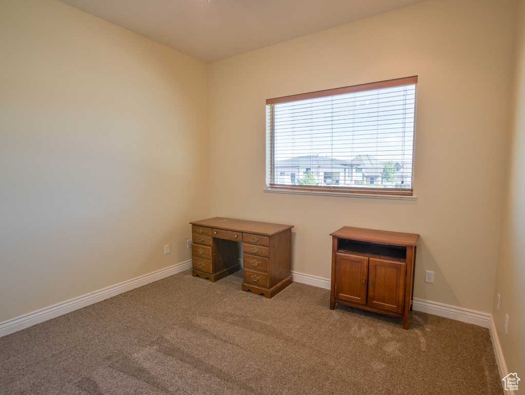 Unfurnished office with carpet and baseboards