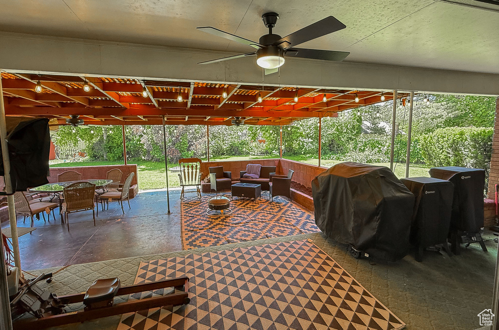 View of patio featuring a ceiling fan, an outdoor living space, outdoor dining space, and a grill
