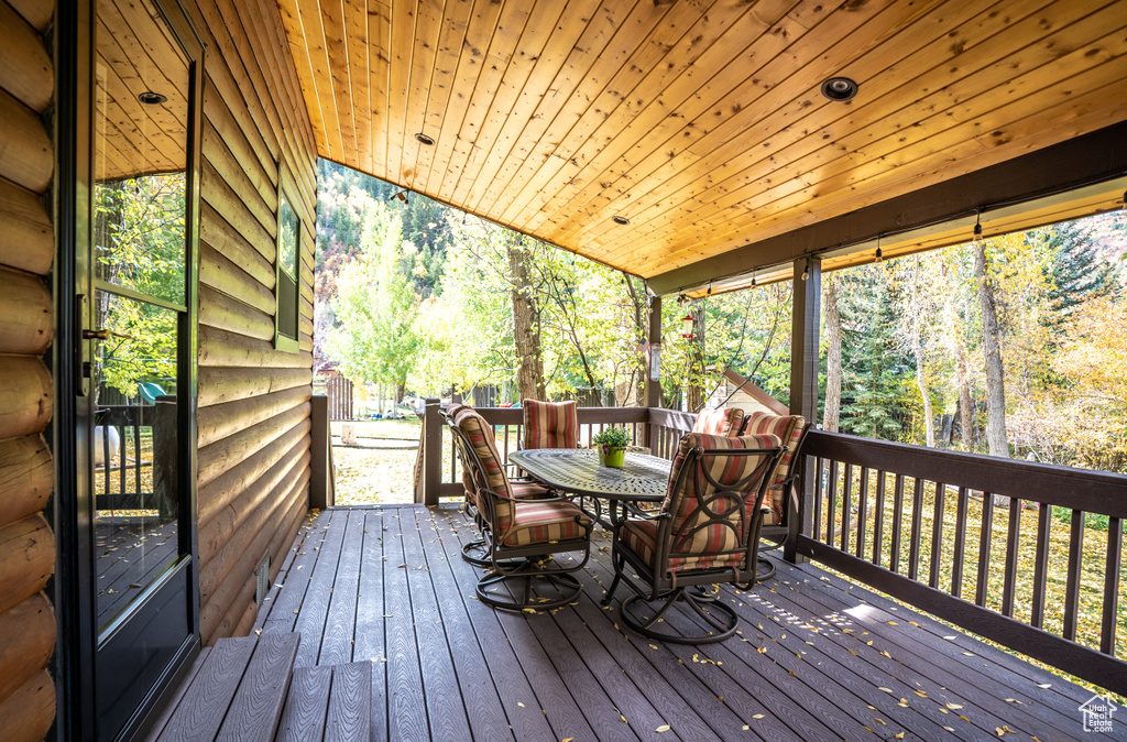 Wooden deck featuring outdoor dining area