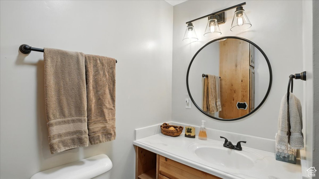 Half bath featuring vanity and toilet