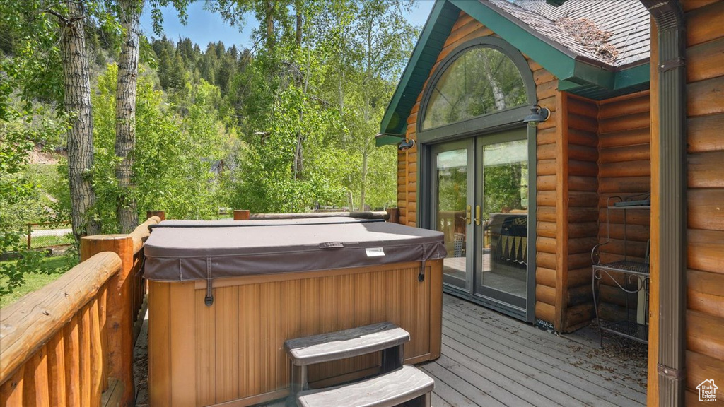 Deck with a hot tub and french doors