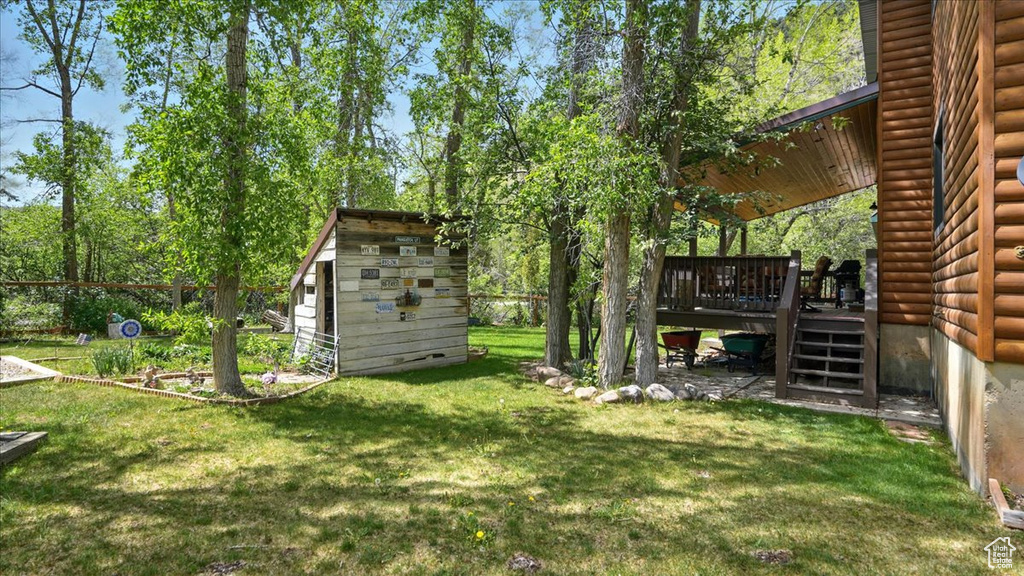 View of green lawn with a wooden deck