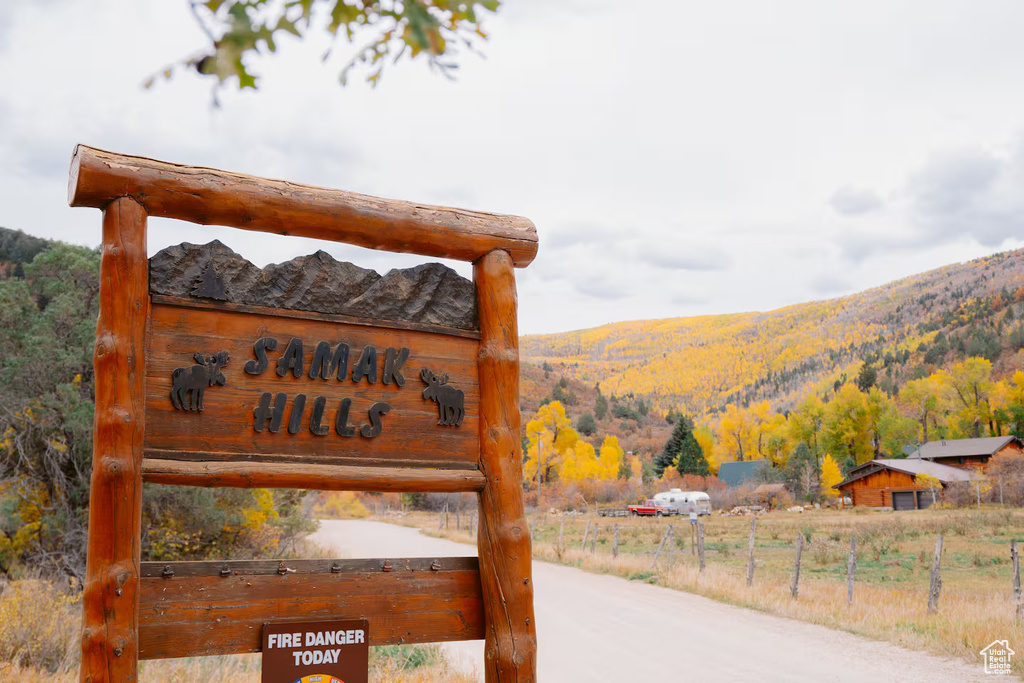 Community / neighborhood sign with a mountain view