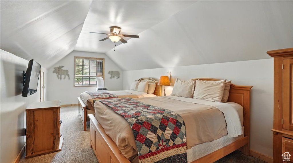 Bedroom featuring carpet flooring, baseboards, lofted ceiling, and a ceiling fan