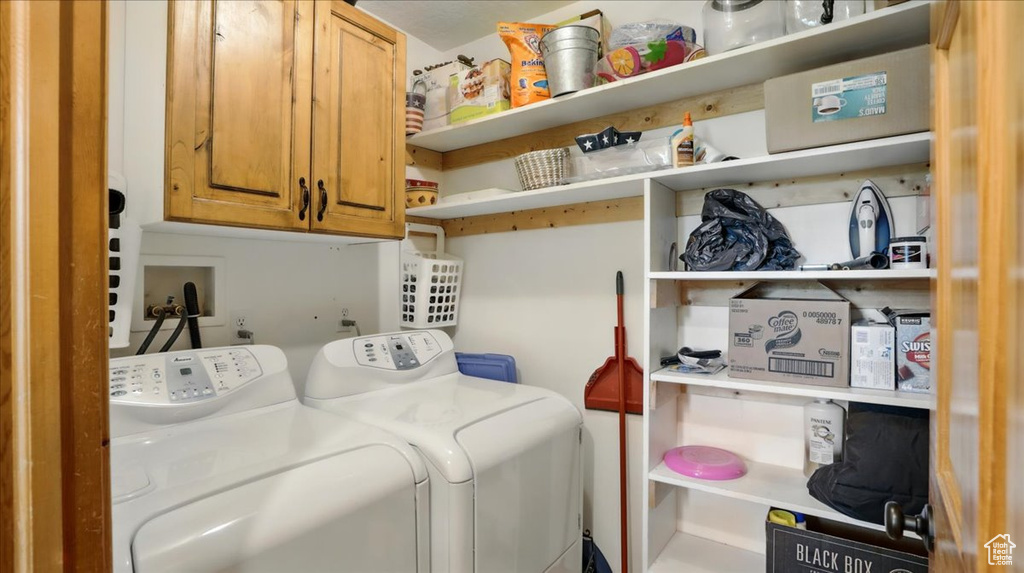 Laundry area featuring cabinet space and washer and dryer