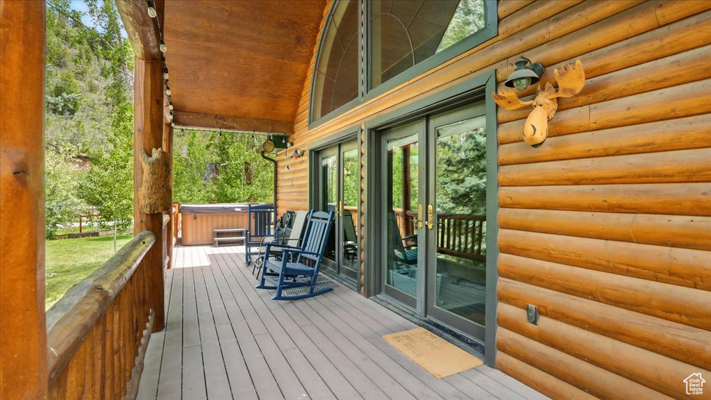 Wooden deck featuring french doors and a hot tub