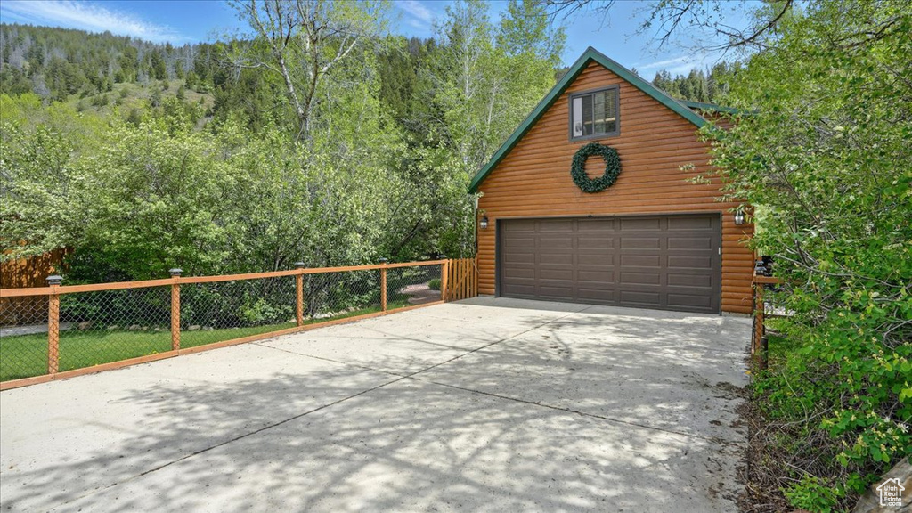 Detached garage with a wooded view