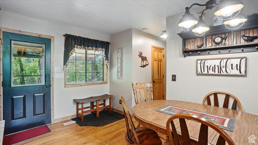 Dining area with light wood-type flooring and baseboards