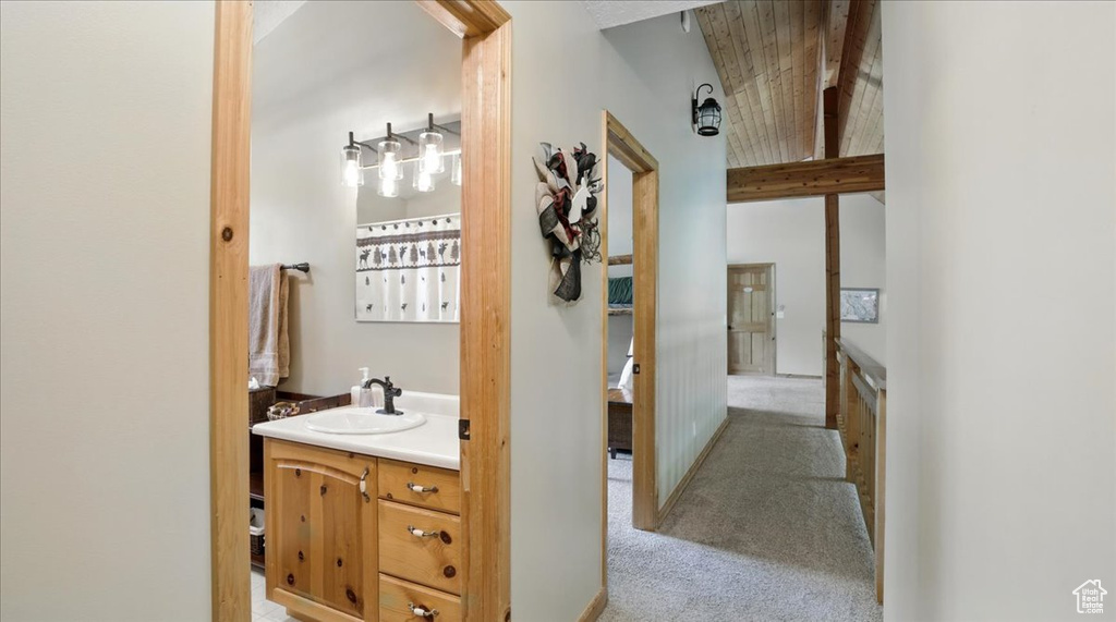 Bathroom featuring vanity and beamed ceiling