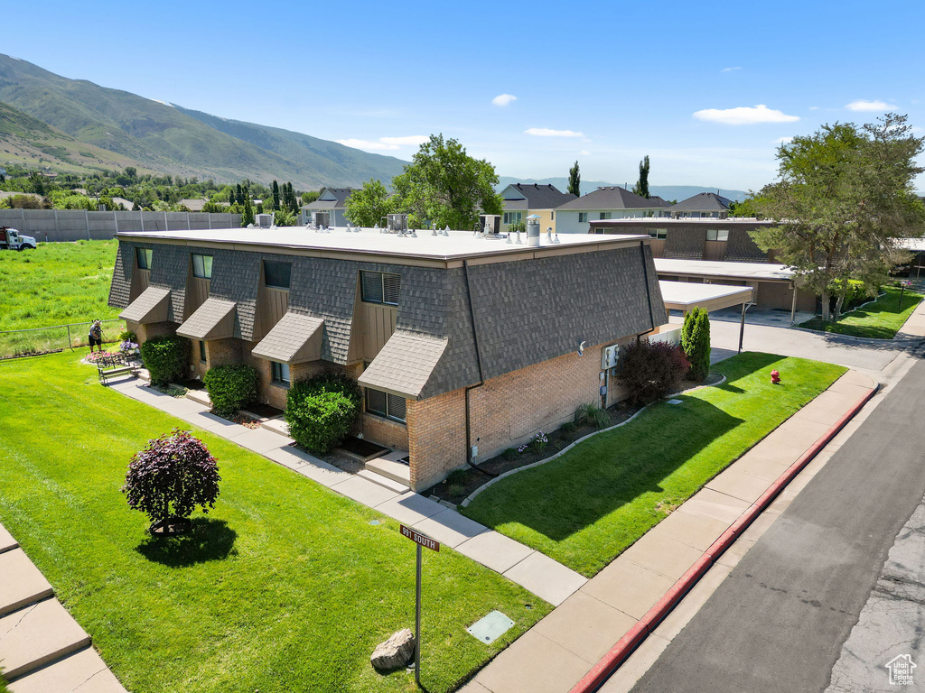 View of home's exterior with brick siding and a mountain view