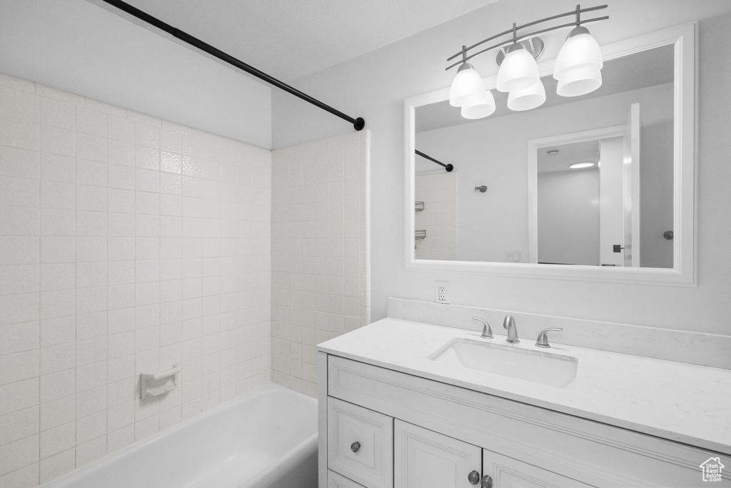 Bathroom featuring vanity and shower / tub combination
