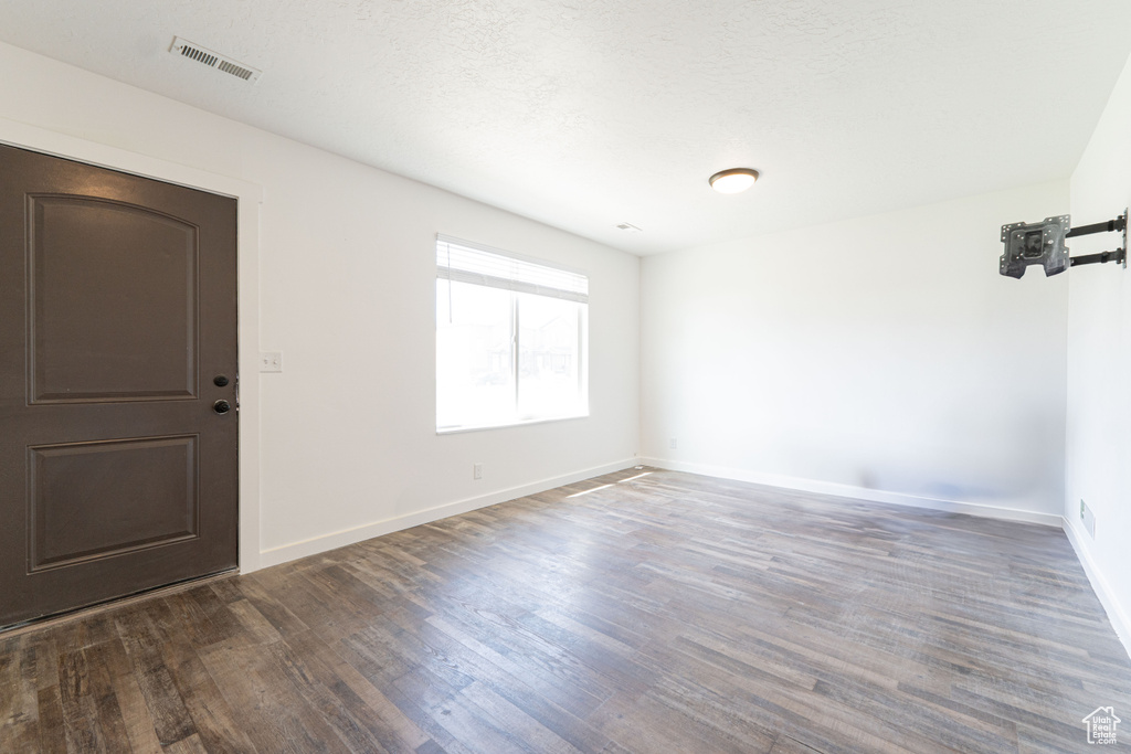 Empty room with wood finished floors and baseboards